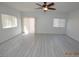 Bright living room with gray floors, natural light, and access to an outdoor patio at 9343 Leaping Deer Pl # 103, Las Vegas, NV 89178