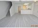 Bright living room with gray floors and staircase at 9343 Leaping Deer Pl # 103, Las Vegas, NV 89178