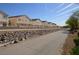 Street view of several two-story homes in a residential neighborhood at 9343 Leaping Deer Pl # 103, Las Vegas, NV 89178