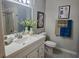 Well-lit bathroom with a large mirror, white cabinets, and shower/tub combo at 950 Seven Hills Dr # 2313, Henderson, NV 89052