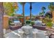 Exterior view of the community grill with a stone table, benches, and manicured plants at 950 Seven Hills Dr # 2313, Henderson, NV 89052