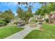 Exterior shot of a community space with seating, grill, grass, and walking path at 950 Seven Hills Dr # 2313, Henderson, NV 89052