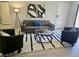 Comfortable living area with sleek gray couch, decorative art, and an inviting black and white rug at 950 Seven Hills Dr # 2313, Henderson, NV 89052