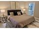 Serene main bedroom with a plush bed, stylish side tables, and a glimpse into the ensuite bathroom at 950 Seven Hills Dr # 2313, Henderson, NV 89052