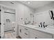 Modern bathroom featuring double sinks, a large mirror, and a luxurious glass-enclosed shower with marble tile at 9540 Eagle Valley Dr, Las Vegas, NV 89134