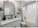 Clean bathroom featuring a single sink vanity with white countertops, a bathtub with shower, and neutral walls at 9540 Eagle Valley Dr, Las Vegas, NV 89134
