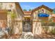 Charming front entrance with a gated courtyard, well-maintained landscaping, and a welcoming aesthetic at 9540 Eagle Valley Dr, Las Vegas, NV 89134