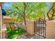 Charming front yard featuring artificial turf, a chair, and a gated entrance, offering a welcoming and low-maintenance outdoor space at 9540 Eagle Valley Dr, Las Vegas, NV 89134
