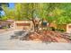 Inviting front yard with mature trees, lush landscaping, and a charming home, creating a welcoming curb appeal at 9540 Eagle Valley Dr, Las Vegas, NV 89134