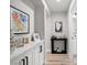Hallway with white cabinets, decorative artwork, and wood flooring leading to the bathroom, enhancing home appeal at 9540 Eagle Valley Dr, Las Vegas, NV 89134