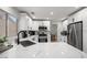 Modern kitchen featuring white cabinets, stainless steel appliances, quartz countertops, and ample counter space at 9540 Eagle Valley Dr, Las Vegas, NV 89134