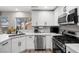 Bright and well-equipped kitchen featuring stainless steel appliances, quartz countertops, and custom cabinetry at 9540 Eagle Valley Dr, Las Vegas, NV 89134