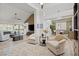 Open concept living room connects to a dining area with vaulted ceilings and large windows at 9540 Eagle Valley Dr, Las Vegas, NV 89134