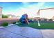 Backyard features a playground, swing set, synthetic grass, pavers, and privacy landscaping at 10152 Tenaya Meadows St, Las Vegas, NV 89178