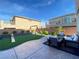 Backyard features a swing set, turf and paver combination with seating at 10152 Tenaya Meadows St, Las Vegas, NV 89178