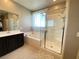 Bathroom featuring a shower, separate tub, and a dark wood cabinet with a sink at 10152 Tenaya Meadows St, Las Vegas, NV 89178
