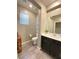 Half bathroom features a stylish vanity, a mirror and neutral color palette at 10152 Tenaya Meadows St, Las Vegas, NV 89178
