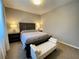 Cozy bedroom featuring a comfortable bed, a bench, and stylish bedside tables and lamps at 10152 Tenaya Meadows St, Las Vegas, NV 89178