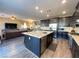 Modern kitchen boasts a large island, stainless steel appliances, and an open floorplan at 10152 Tenaya Meadows St, Las Vegas, NV 89178