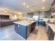 Modern kitchen boasts a large island, stainless steel appliances, and an open floorplan at 10152 Tenaya Meadows St, Las Vegas, NV 89178
