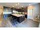 Spacious kitchen features dark cabinetry, a large center island, and stainless steel appliances at 10152 Tenaya Meadows St, Las Vegas, NV 89178