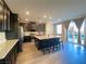 Bright kitchen featuring stainless steel appliances, an island with stools and sliding glass doors at 10152 Tenaya Meadows St, Las Vegas, NV 89178