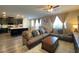 Open floor plan shows a kitchen with island connected to a living room with neutral furnishings at 10152 Tenaya Meadows St, Las Vegas, NV 89178