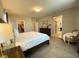 Bright main bedroom featuring a walk-in closet, dark wood furniture, and neutral-toned walls at 10152 Tenaya Meadows St, Las Vegas, NV 89178