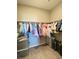This walk-in closet has space for both hangers and storage bins at 10152 Tenaya Meadows St, Las Vegas, NV 89178