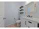 Charming powder room featuring a white vanity with a rectangular mirror and modern fixtures at 10373 Northern Hills Ave, Las Vegas, NV 89166