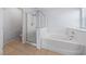 Bathroom featuring a soaking tub, separate glass enclosed shower, and tile flooring at 10373 Northern Hills Ave, Las Vegas, NV 89166