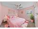 Cheerful pink bedroom featuring a plush bed, unique wall decor, bright natural light, and stylish accents at 10373 Northern Hills Ave, Las Vegas, NV 89166
