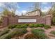 Community entrance featuring lush landscaping and a brick wall at 10373 Northern Hills Ave, Las Vegas, NV 89166