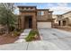 Charming two-story home featuring a stone accented entrance, desert landscaping, and a two car garage at 10373 Northern Hills Ave, Las Vegas, NV 89166