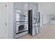 Modern kitchen featuring stainless steel appliances and double oven with sleek cabinets, and tile flooring at 10373 Northern Hills Ave, Las Vegas, NV 89166