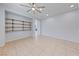 Spacious living room featuring custom shelving and tiled flooring at 10373 Northern Hills Ave, Las Vegas, NV 89166