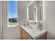 Bathroom features an elegant faucet, white countertop, and a large window with a view at 10528 Garden Light Dr, Las Vegas, NV 89135