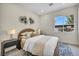 Cozy bedroom features a stylish geometric rug, a modern lamp, and a bright window view at 10528 Garden Light Dr, Las Vegas, NV 89135