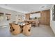 Open-concept kitchen with dining table, modern cabinetry, and an eat-in island at 10528 Garden Light Dr, Las Vegas, NV 89135