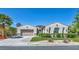 Charming single-story home with a well-manicured lawn, inviting entrance, and a spacious two-car garage at 10528 Garden Light Dr, Las Vegas, NV 89135
