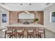 Stylish kitchen with a large island, modern lighting, and sleek wood cabinetry at 10528 Garden Light Dr, Las Vegas, NV 89135