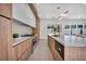 Gourmet kitchen featuring a large island, stainless steel appliances, and wood-grain cabinets at 10528 Garden Light Dr, Las Vegas, NV 89135
