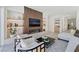 Open-concept living area featuring a fireplace, stylish seating, and views of other rooms at 10528 Garden Light Dr, Las Vegas, NV 89135