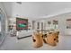 Spacious living room with a glass dining table and fireplace, offering a modern design at 10528 Garden Light Dr, Las Vegas, NV 89135