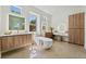 Elegant main bathroom featuring dual vanities, a freestanding tub, and a separate makeup vanity at 10528 Garden Light Dr, Las Vegas, NV 89135