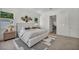 Spacious main bedroom showcasing a decorative headboard, neutral tones and view to en-suite bath at 10528 Garden Light Dr, Las Vegas, NV 89135