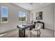 Home office features a modern desk, oversized windows, and stylish decor at 10528 Garden Light Dr, Las Vegas, NV 89135