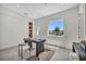 Bright office features a large window, built in bookcase, and modern furniture at 10528 Garden Light Dr, Las Vegas, NV 89135