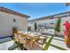 Stylish patio area with an outdoor kitchen, complete with a built-in barbecue and dining table at 10528 Garden Light Dr, Las Vegas, NV 89135