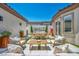 Charming outdoor living space with comfortable seating and a dining area with a built-in outdoor kitchen at 10528 Garden Light Dr, Las Vegas, NV 89135